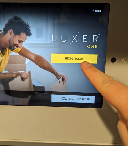 A finger pointing at a screenDescription automatically generated